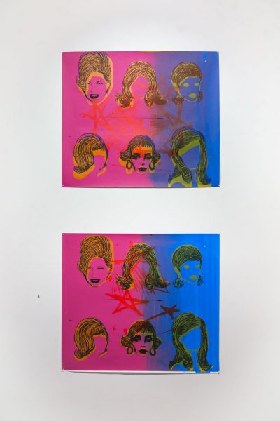Two prints that are rectangular with a pink to blue horizontal gradient background and six silhouettes of faces and hair printed on top in two rows of three, there are red stars drawn on top in the center of each print