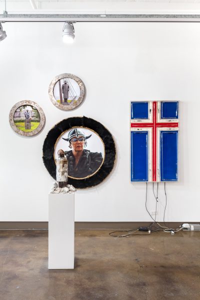 Installation view of several Icelandic themed artworks varying from a neon Icelandic flag and photographs ofViking memorabilia.