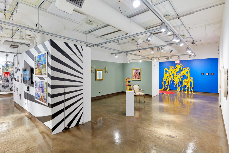 Installation view of gallery space with boldly colored and graphic walls
