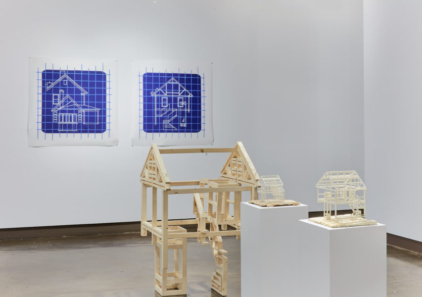 Exhibition Sticks and Stones May Break My Bones But Words Will never Hurt Me 2019. SVA Chelsea Galleries,New York. Artwork by Xiaoyu (Jade) Li. Three wooden skeletal structure homes. Two architecture blueprints hanging from the wall.