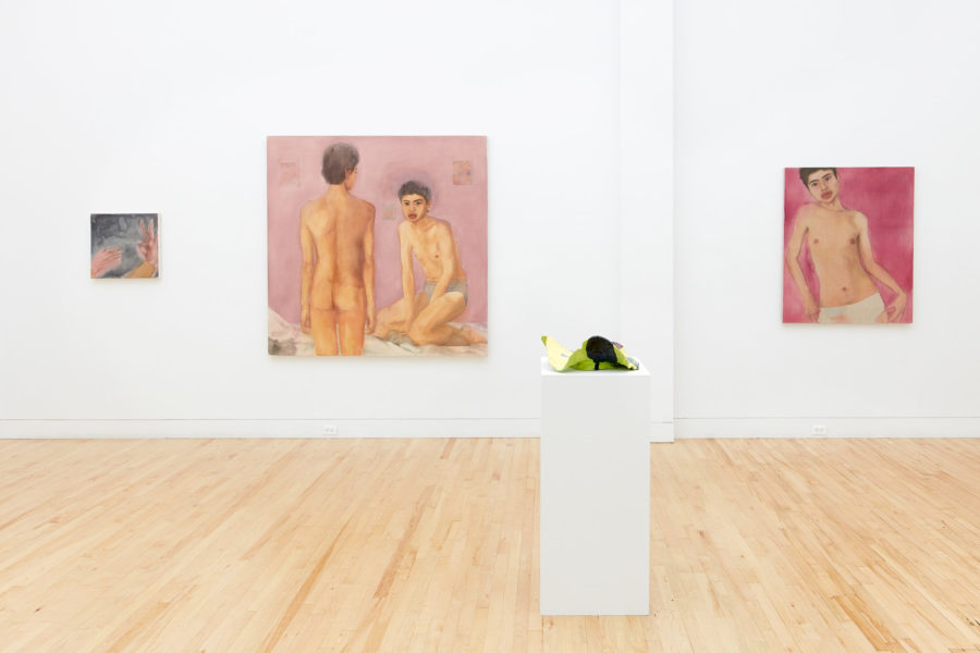 Exhibition Tales and Whispers 2019. SVA Flatiron Gallery, New York. Installation image featuring multiple paints of figures. In the center of the room in a sculpture placed on top of a pedestal.