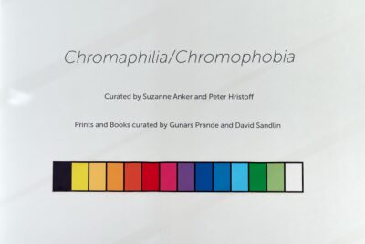 Exhibition Poster for Chromaphilia/Chromophobia with a rainbow of colors across the bottom.
