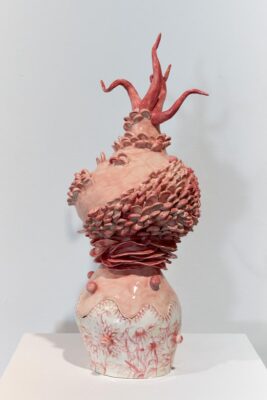 Ceramic glazed organic sculpture painted in warm pastel tones.