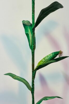Close up of a green sculpture of a corn plant.