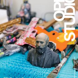 A poster advertising spring 2018 open studios for the BFA Fine Arts program at SVA. The background of the poster is a photograph of a table with a blue table cloth and paint brushes, paints, and a miniature sculpture of person's head and upper body on the table. The text is written in white block letters.