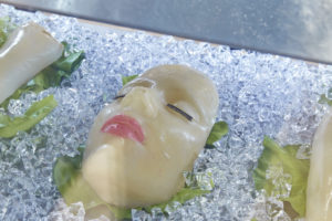 Detail of a simulation of a deli case with sculptures resembling body parts.
