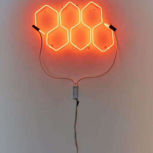 Artwork by Melissa Rose Pressler. BFA Fine Arts, 2019. Installation view. Neon sign with six orange hexagons.