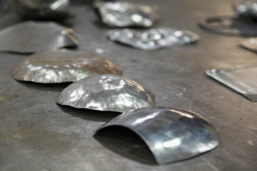 Thin sheets of small metal shaped in rounded pieces.