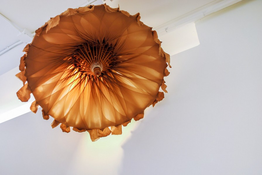 Brown chandelier made of fabric and installed on the ceiling.