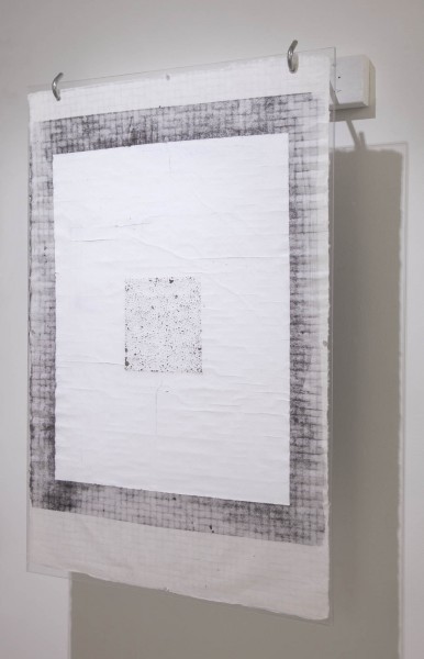 A view of a painting with a dark outer square with tiny square pattern and inside of the first square is a plain white square and inside of the white square is a smaller bright grey with textures in it.