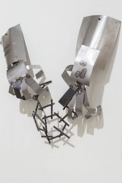 Detailed view of metallic hands welded together from small metal pieces by Alex Jerome.