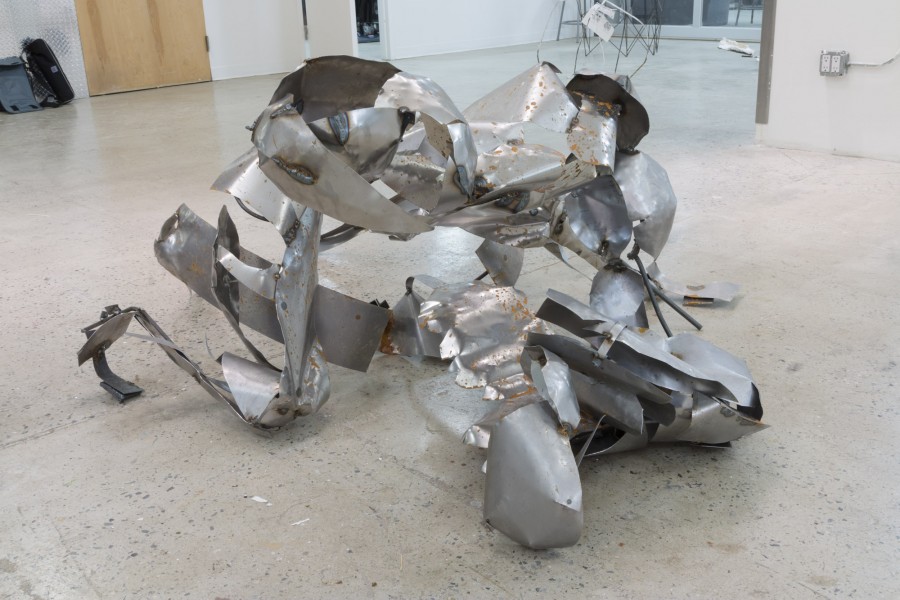 Metal sculpture made of metal sheets with curved forms.