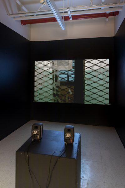 Installation view of artwork by Alexandra Russo. View of a projection on a black wall.