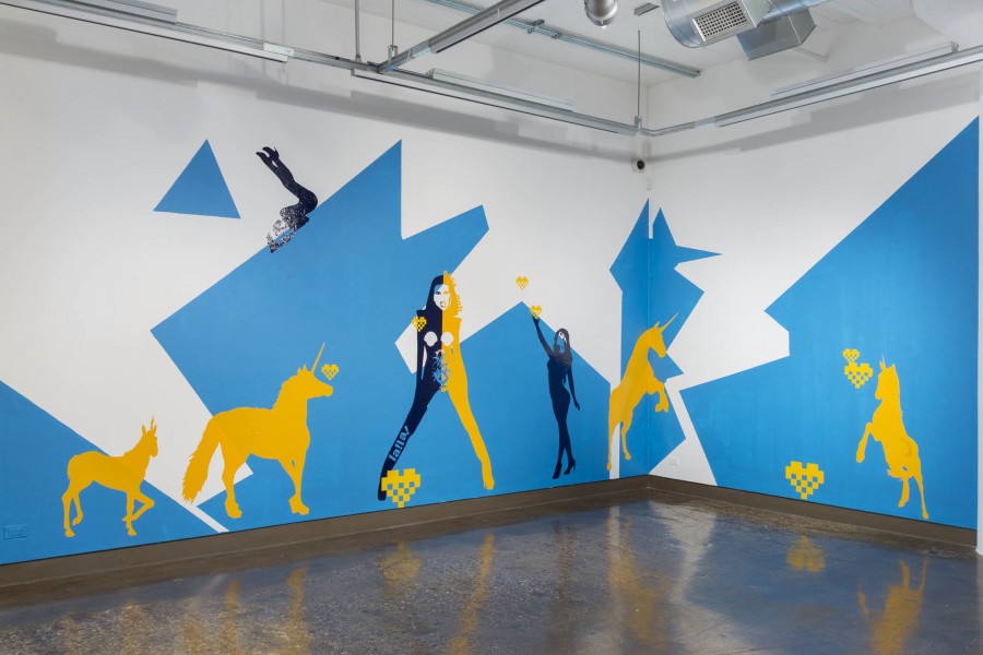 Exhibition view of "Mother Monster", a large scale wall installation colored in blue, yellow, and black.