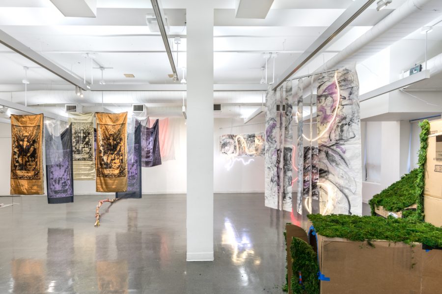 View of an installation by Artemis Razzberry. Multiple screen-printed textiles depicting tarot cards.