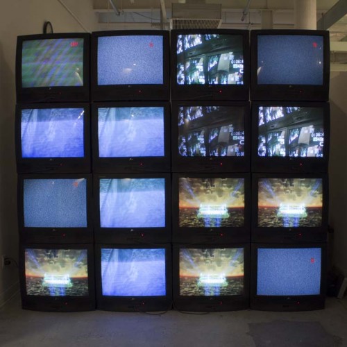 A grid of eight TVs with different images displayed, which may contain sky and clouds and images of miscellaneous objects