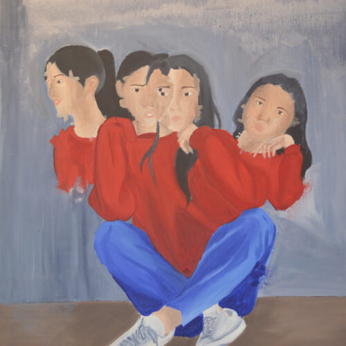 A figure with blue jeans, white sneakers, a red shirt and multiple torsos sits cross-legged, facing forward. All of the torsos have similar heads with long dark hair.