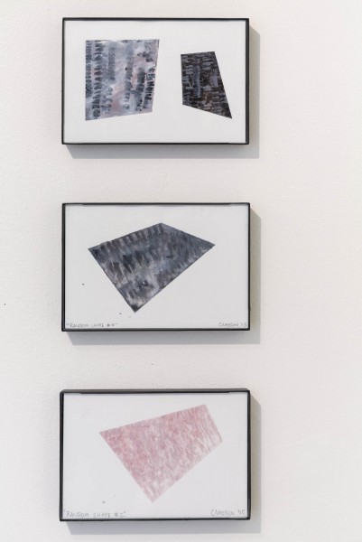 An overview of three stacked artworks by Cameron Richie. The first painting is about two geometric shapes colored in black, grey, and dark red. The second painting is about a black trapezoid shape. The third painting is about a pink trapezoid shape.