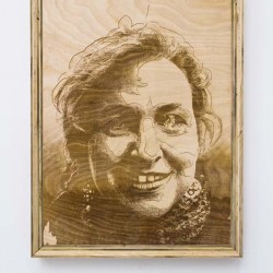 A portrait on the wood surface in a wooden frame of a person with some hair on the forehead and a scarf on the neck
