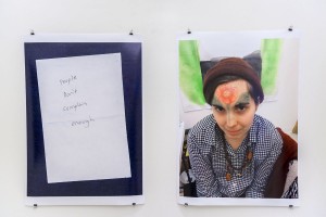 Two prints on paper: a hand-written message on the left side and a portrait of a girl with a flower painted on her face on the right side by Cassidy Toner.
