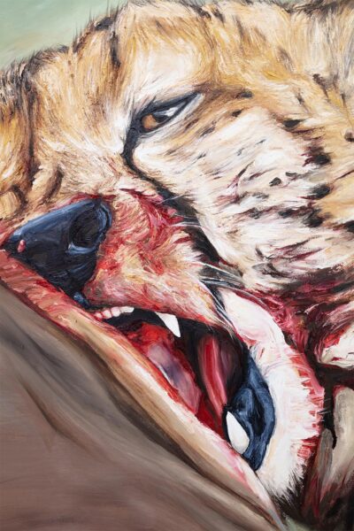 Close-up of the face of a hyena with blood in her snout.