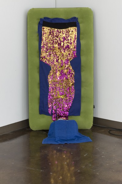 Inflatable green mattress with a blue fabric and a sequins fabric colored in purple and gold.