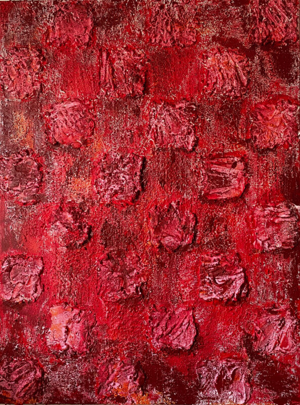 An irregular grid in shades of red with a raised texture.