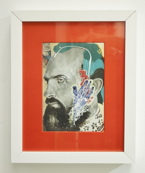 Profile portrait of a man with beard and mustache and abstract drawings over his ear, on an orange frame installed inside a white wooden frame. 