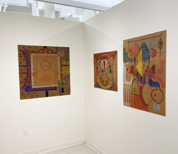 Installation shot of 3 pencil drawings with colorful geometric shapes