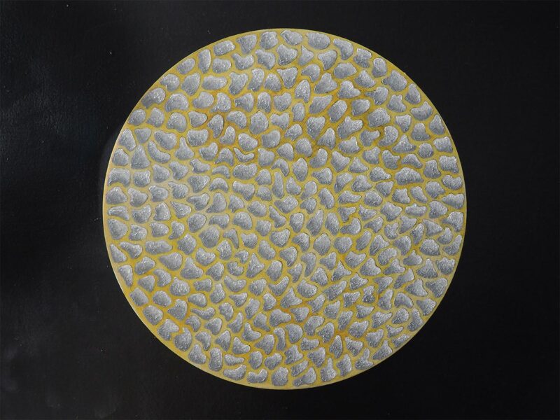 An abstract painting of irregular gray shapes on a yellow ground. Painting is on a round wood panel.