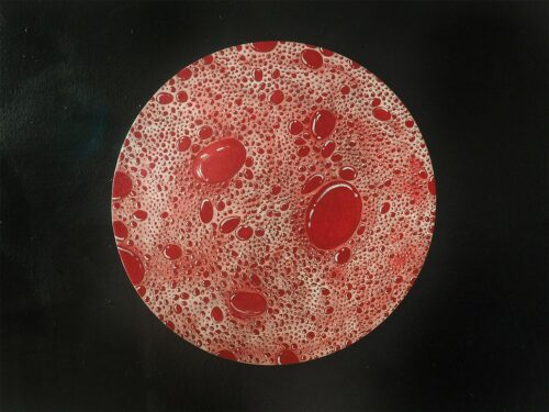An abstract painting showing variously sized red dots with white highlights on a light red ground.