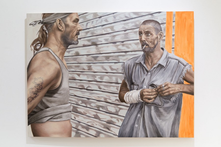 The painting represents a man with a bandana on the forehead and a white undershirt, a tattoo on the arm facing to the right side. On the right side is another man with a cigarette in his mouth, wearing a grey shirt without arms, a bandage on the left arm, and closing his chest pocket. Behind the men are a garage door and a small portion of an orange wall on the right side of the frame