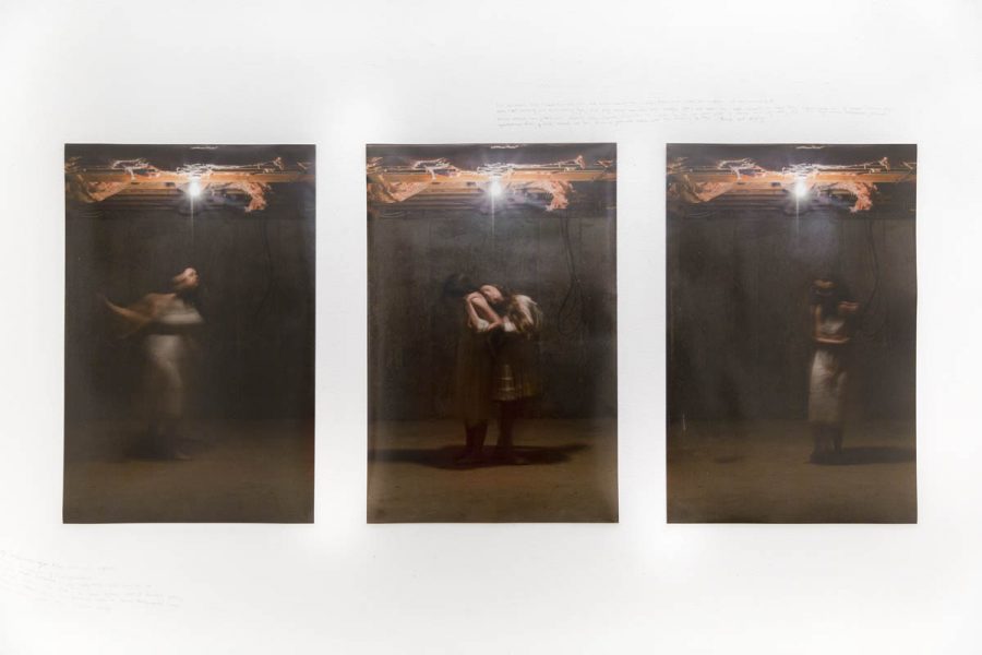 There are three prints with a woman tied with a cord from e metal structure in the ceiling near the lightbulb. The woman appears to be moving in the first and the third photo, but she stands still in the middle photo