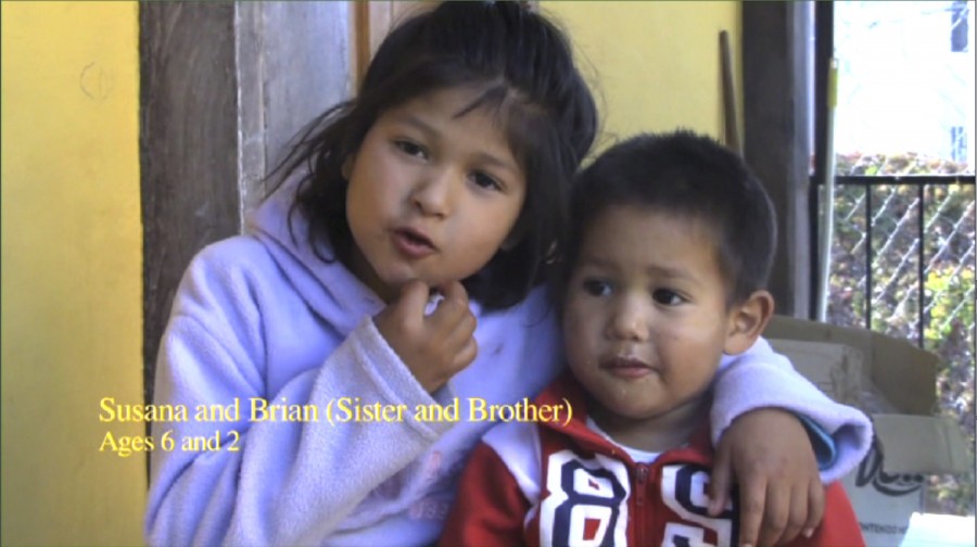 Screen capture from a clip of two children hugging and a caption: Susan and Brian (Sister and Brother). Age Six and two.