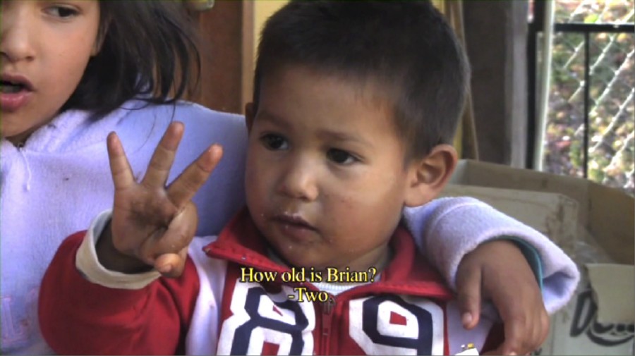 Screen capture from a clip of a boy OK sign with his hand and a caption: How old is Brian? and the answer: Two.