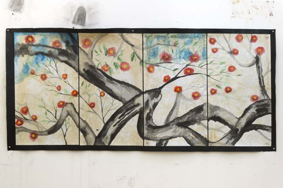Tree branches painting made out of four individual paper pieces, illustrating red flowers growing on branches and a few green leaves