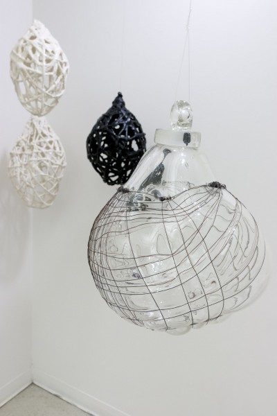 A rounded glass globe covered with a wire mesh
