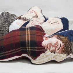 Pillows made of organic fabric and embodiments represent a person sleeping while covered with red and brown flannel blankets, blue pillows, etc.