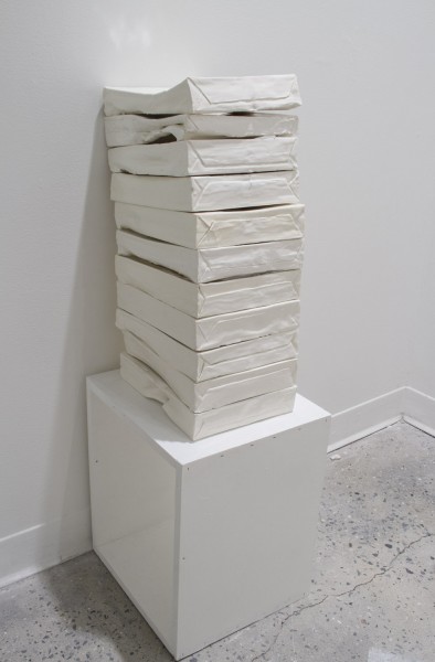 Closer look of the installation of paper packs stacks made out of ceramic by Emily Palmer.