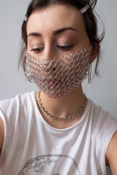 Emma Fasciolo wearing a chainmail mask.
