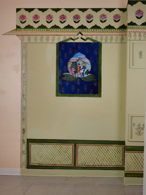 Inspired by the early days of the pandemic, this painting shows two demons fighting over a paper towel in a somewhat erotical manner in the middle of a fantastical garden. The wooden frame cut out in a shape of a motif acts as a window to this moment. The painting sits inside a Jharoka, a type of overhanging enclosed balcony used in the architecture of Rajasthan, painted with house paint directly on the wall.