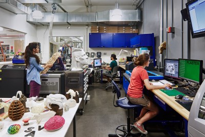 An interior view of the Digital Sculpture Lab showing students and staff working together.
