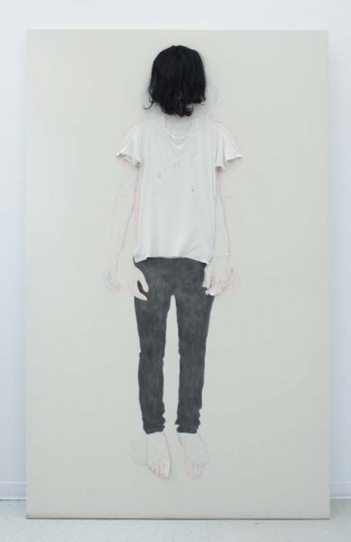 A faceless full-body portrait of a person with a white t-shirt and black pants with hair covering the face