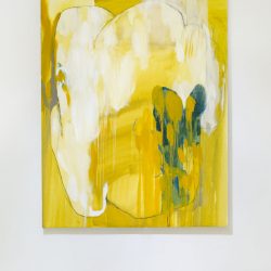 Rectangular abstract painting of yellow with a blue shape in the foreground and a medium yellow background, very drippy.