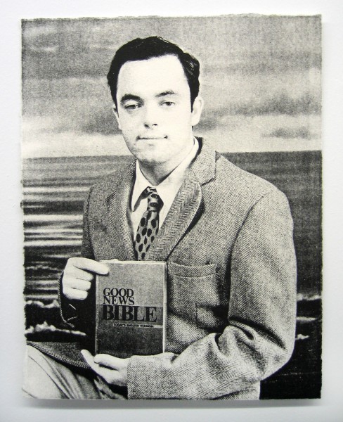A black and white portrait of a man holding a book titled "Good News Bible."