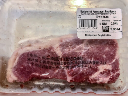 A packed piece of steak with  a barcode label reading "Registered Permanent Resident, Born, Raised, Harvested in China", and priced at $3.5M