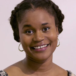A photograph of Ilana Harris-Babou. The photograph is a headshot of Ilana smiling at the camera.
