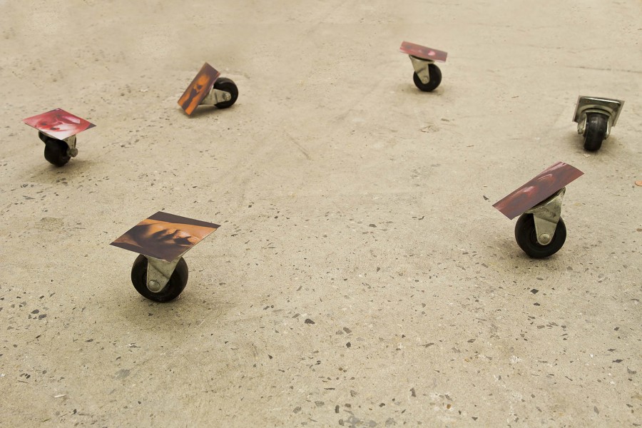 Six dolly wheels with colorful prints glued on the ground with adhesive.