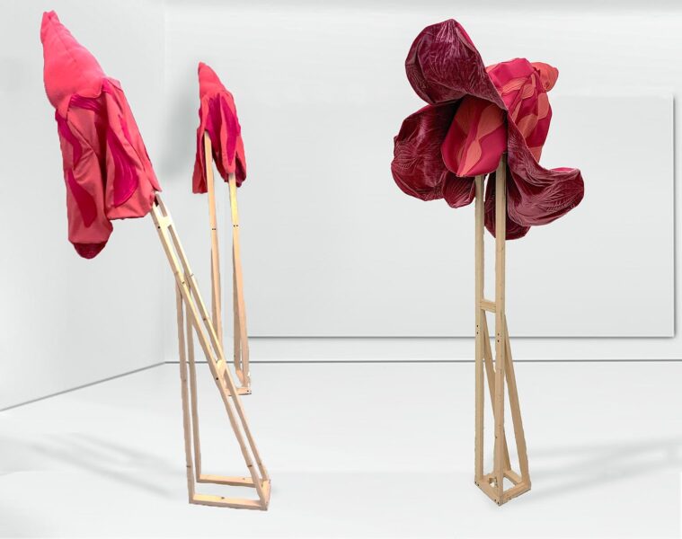Mackettes of wooden stands with red paper flowers.