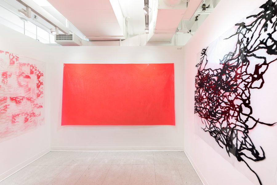 Installation view of artwork by Jonathan Perkins. Abstract paintings with a predominately red hues.